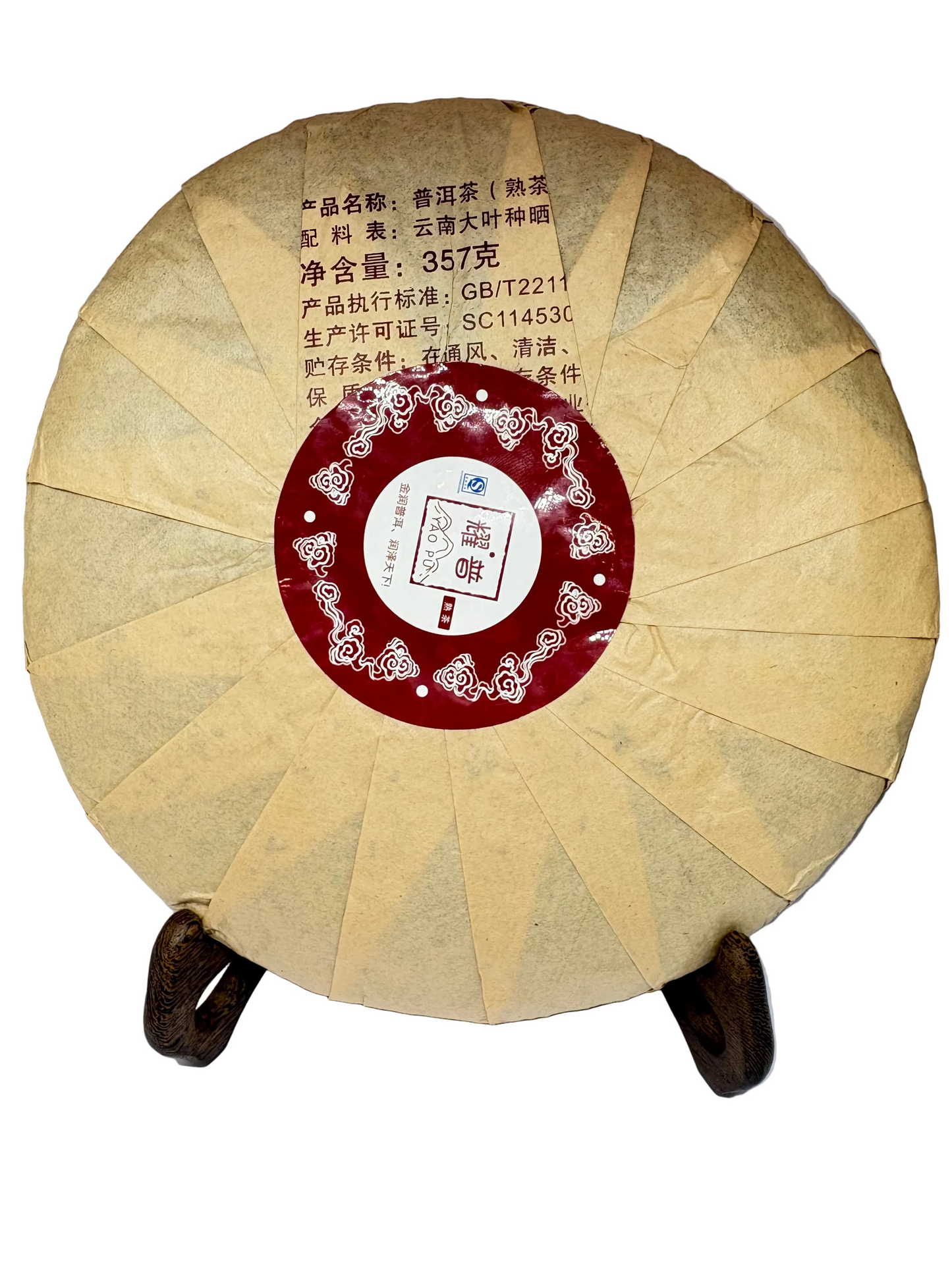 Round tea cake with a red label on a white background